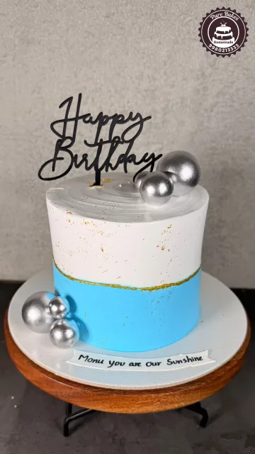 Blue and White Birthday Cake with Silver Balls Decor