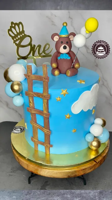 Blue Teddy First Birthday Cake with Ladder and Balloon Decor