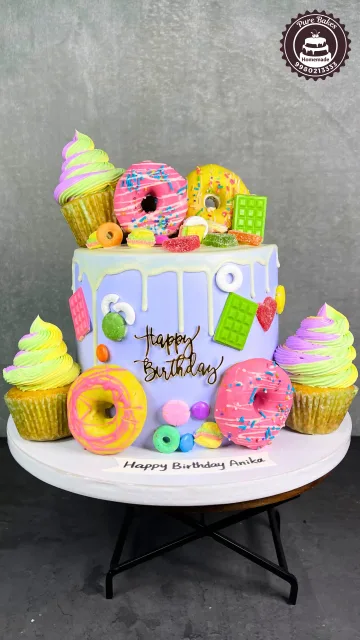 Colorful Donut Theme First Birthday Cake With Candy Toppers