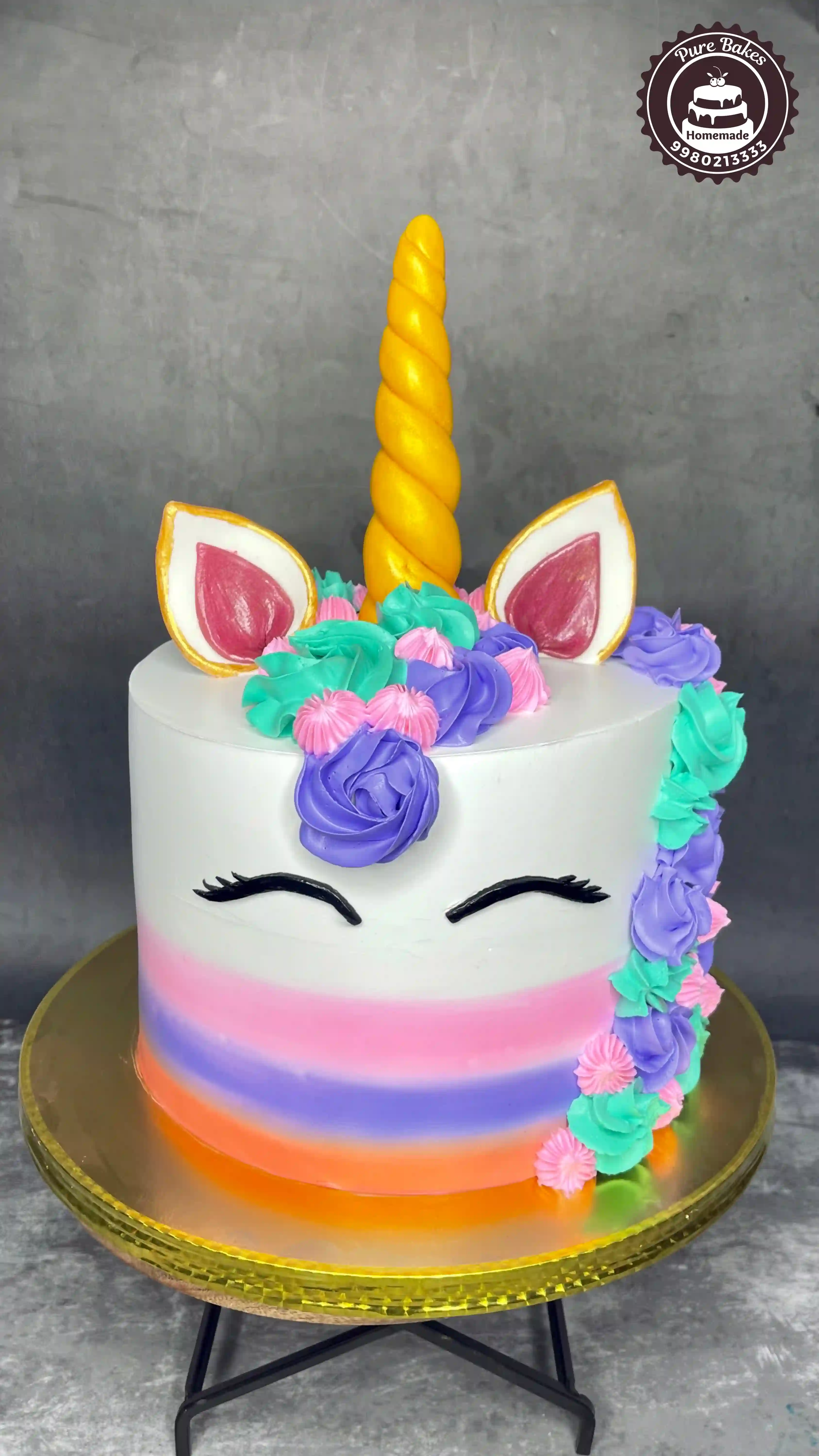 Colourful unicorn birthday cake with rainbow frosting created by PureBakes