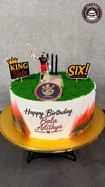 Cricket themed birthday cake with a batsman topper, Royal Challengers emblem, King Bala message, and six cricket decoration