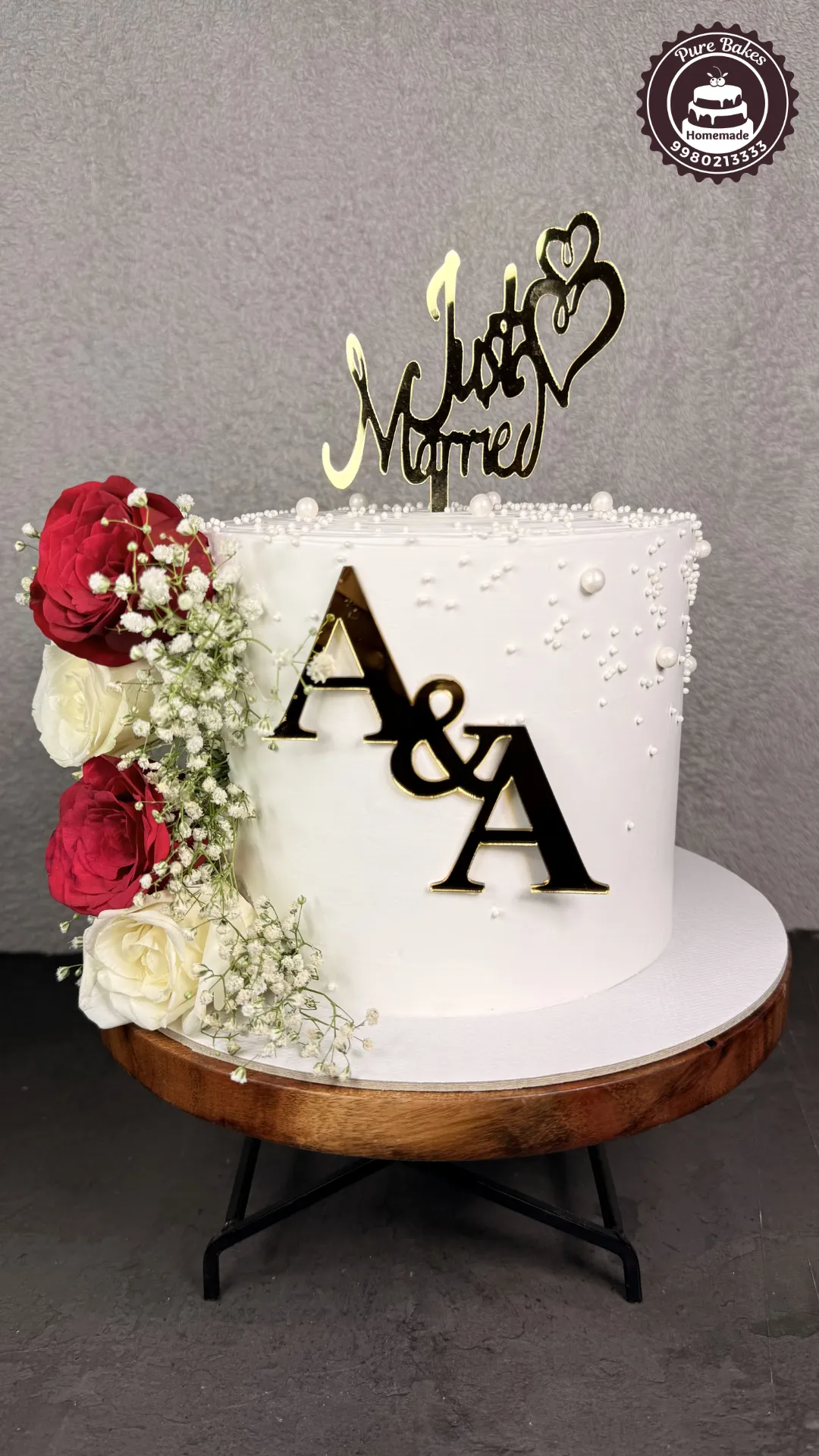 Anniversary cake with fresh roses and gold accents created by PureBakes