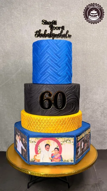 Elegant three tier blue black and gold sixtieth birthday celebration cake with personalized photo panels