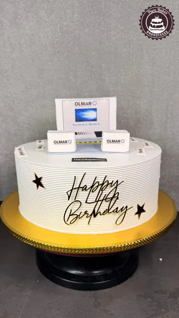 Elegant white corporate birthday cake featuring office themed edible decorations and personalized branding