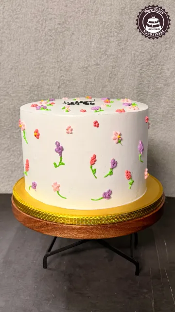 Minimalist White Birthday Cake with Colorful Buttercream Flower Details