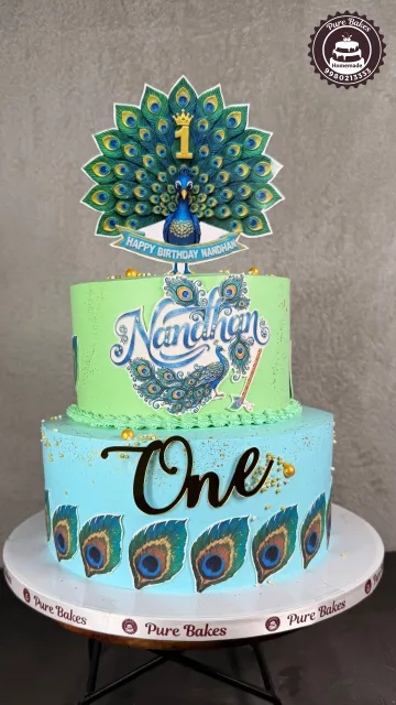 Peacock Theme First Birthday Cake with Custom Name Topper