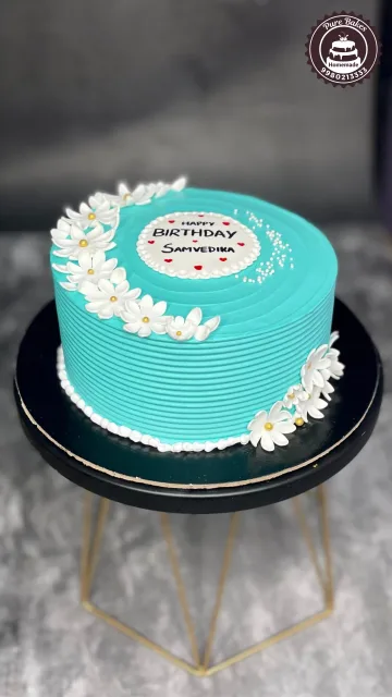 Sky Blue Birthday Cake with White Daisy Decorations