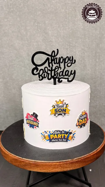 White birthday cake celebrating a super dad and best son with colorful edible decorations
