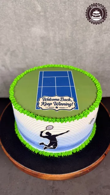 Green tennis themed celebration cake featuring a tennis court design and Keep Winning message