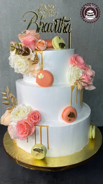 White Three Tier Birthday Cake with Roses and Macarons