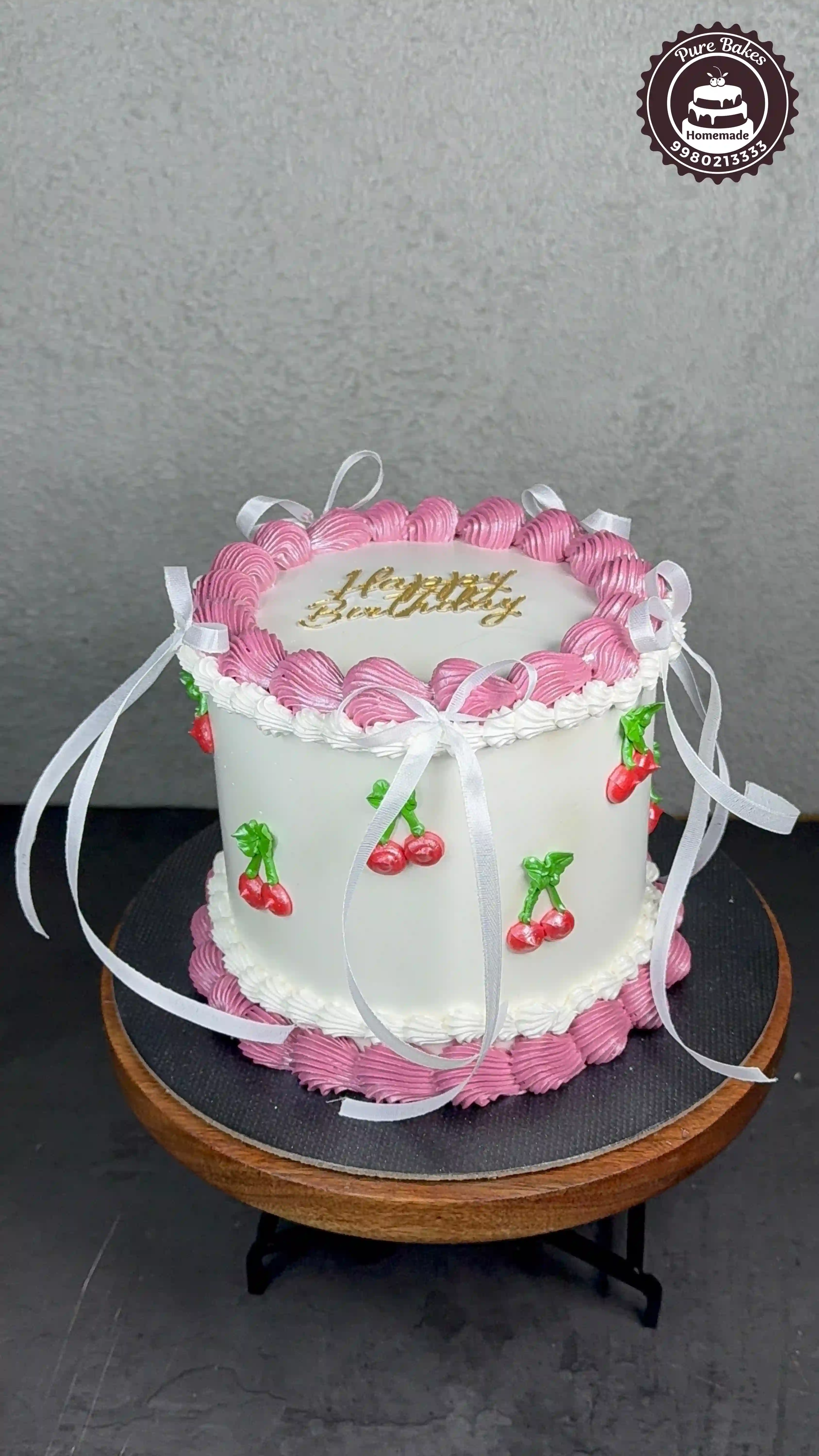 Cherry Ribbon Birthday Cake with Pink Buttercream Design