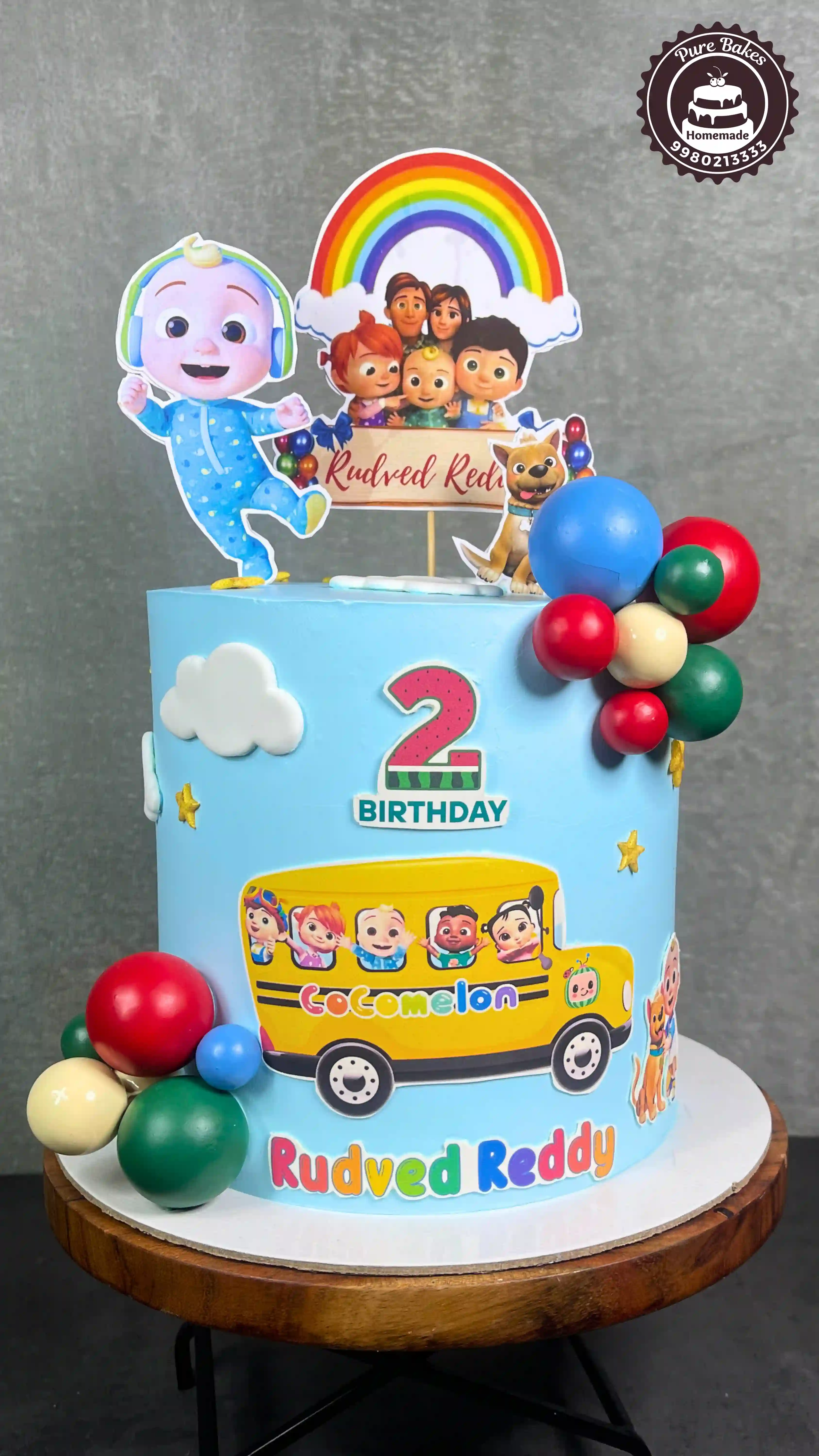Cocomelon Second Birthday Cake with Colorful Balloon Decorations