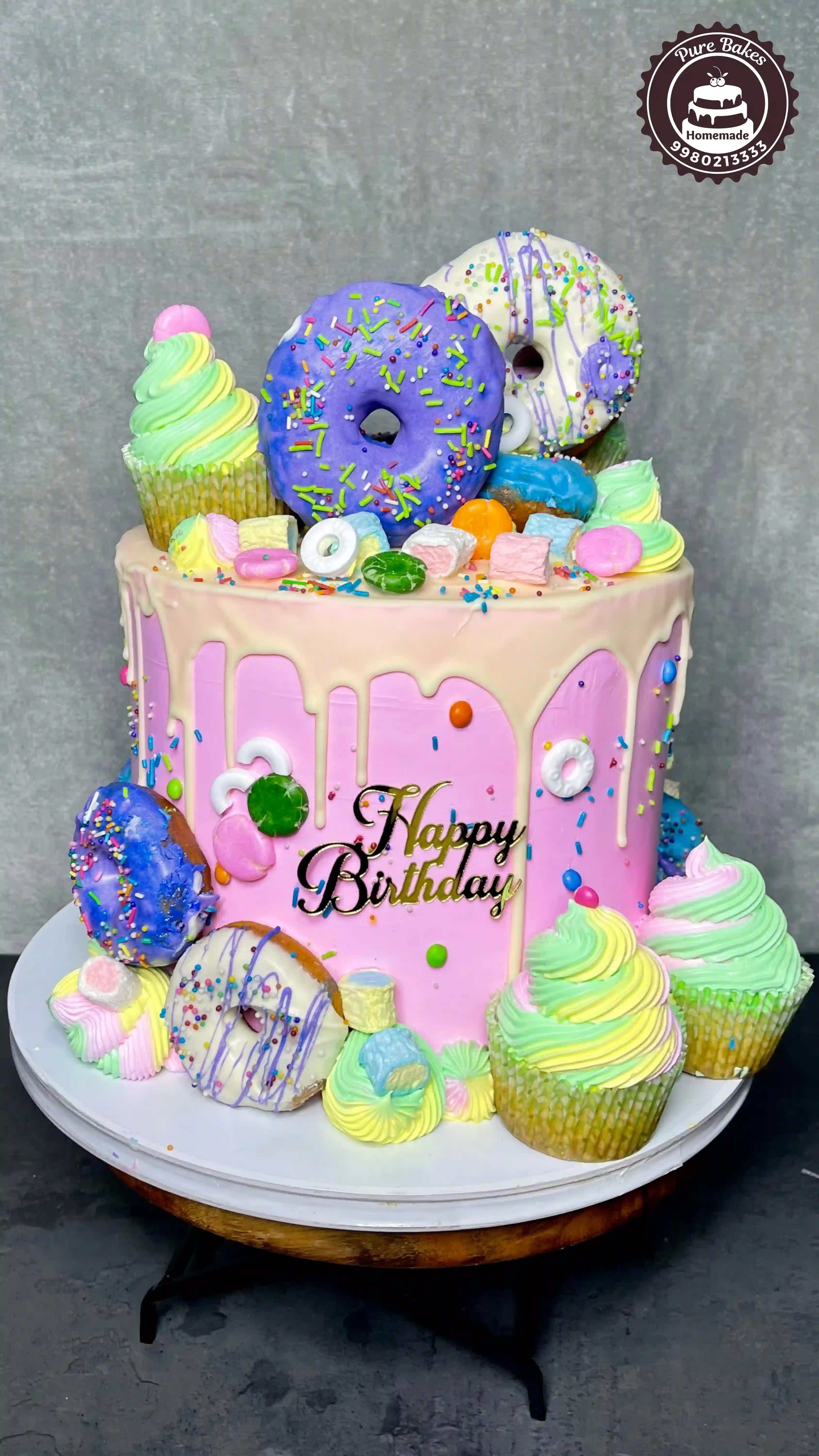 Colorful Donut Birthday Cake with Sprinkles and Cupcake Toppers