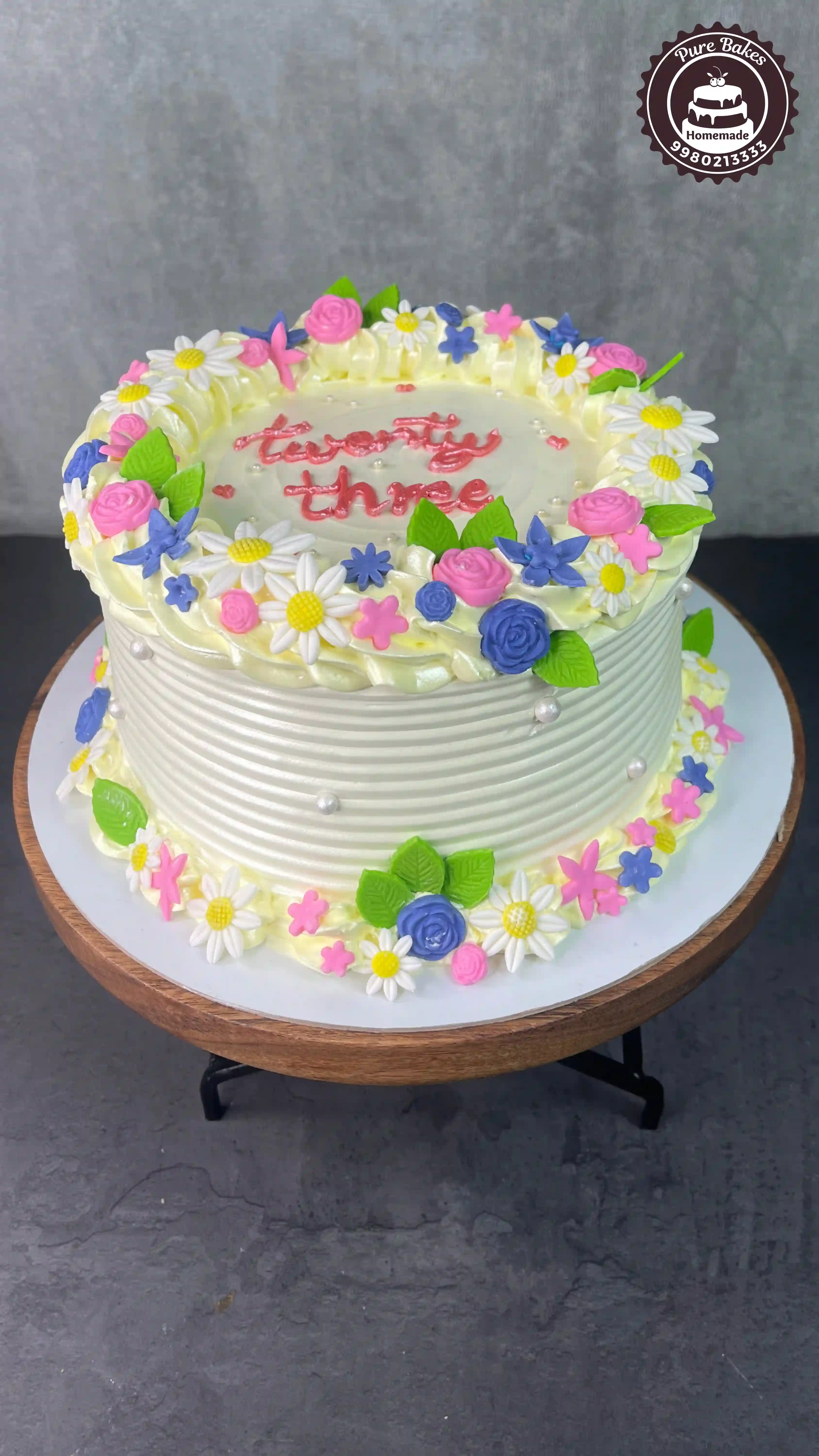 Whimsical Daisy Garden Birthday Cake with Colorful Buttercream Flowers