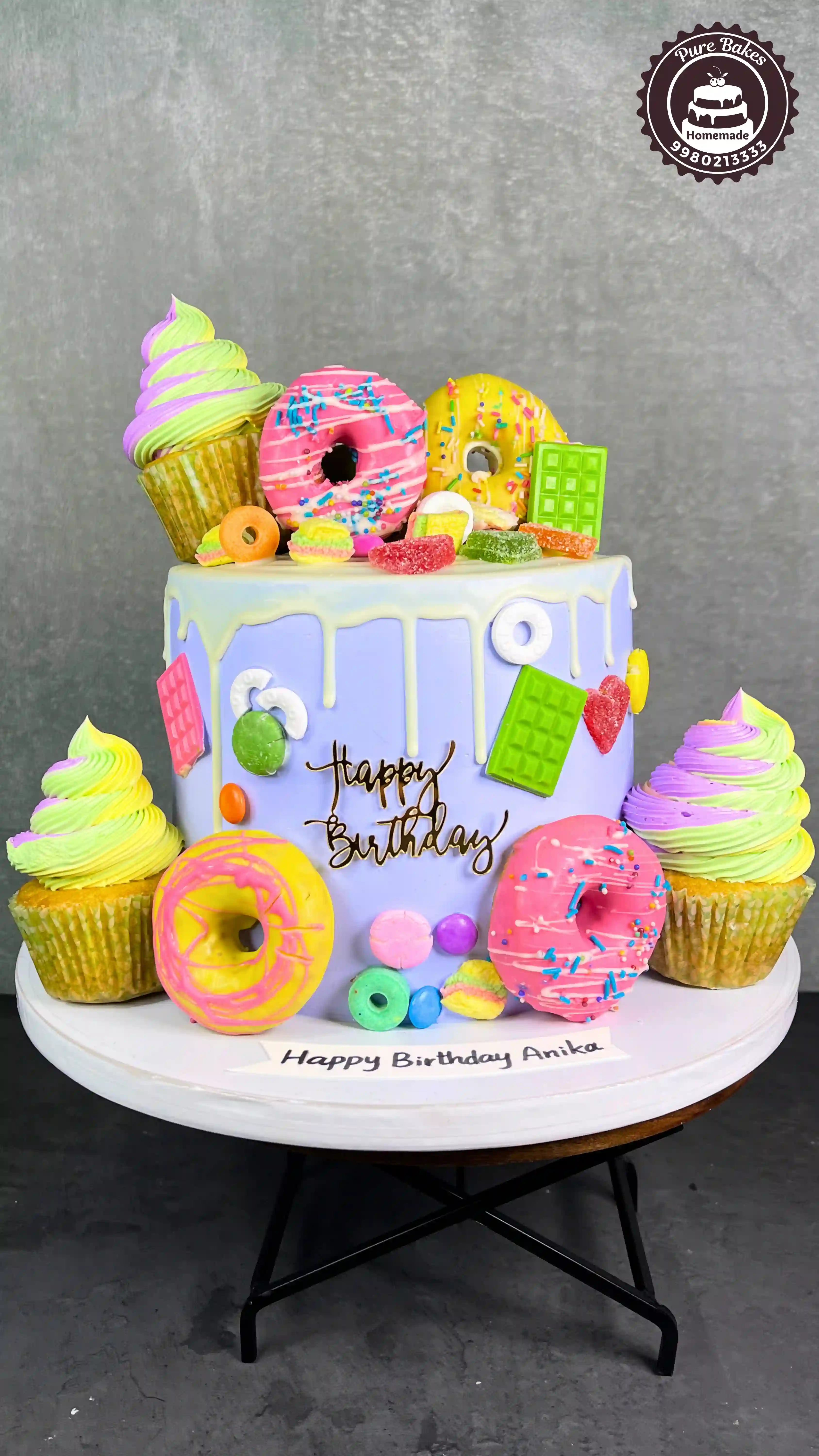 Colorful Donut Theme First Birthday Cake With Candy Toppers