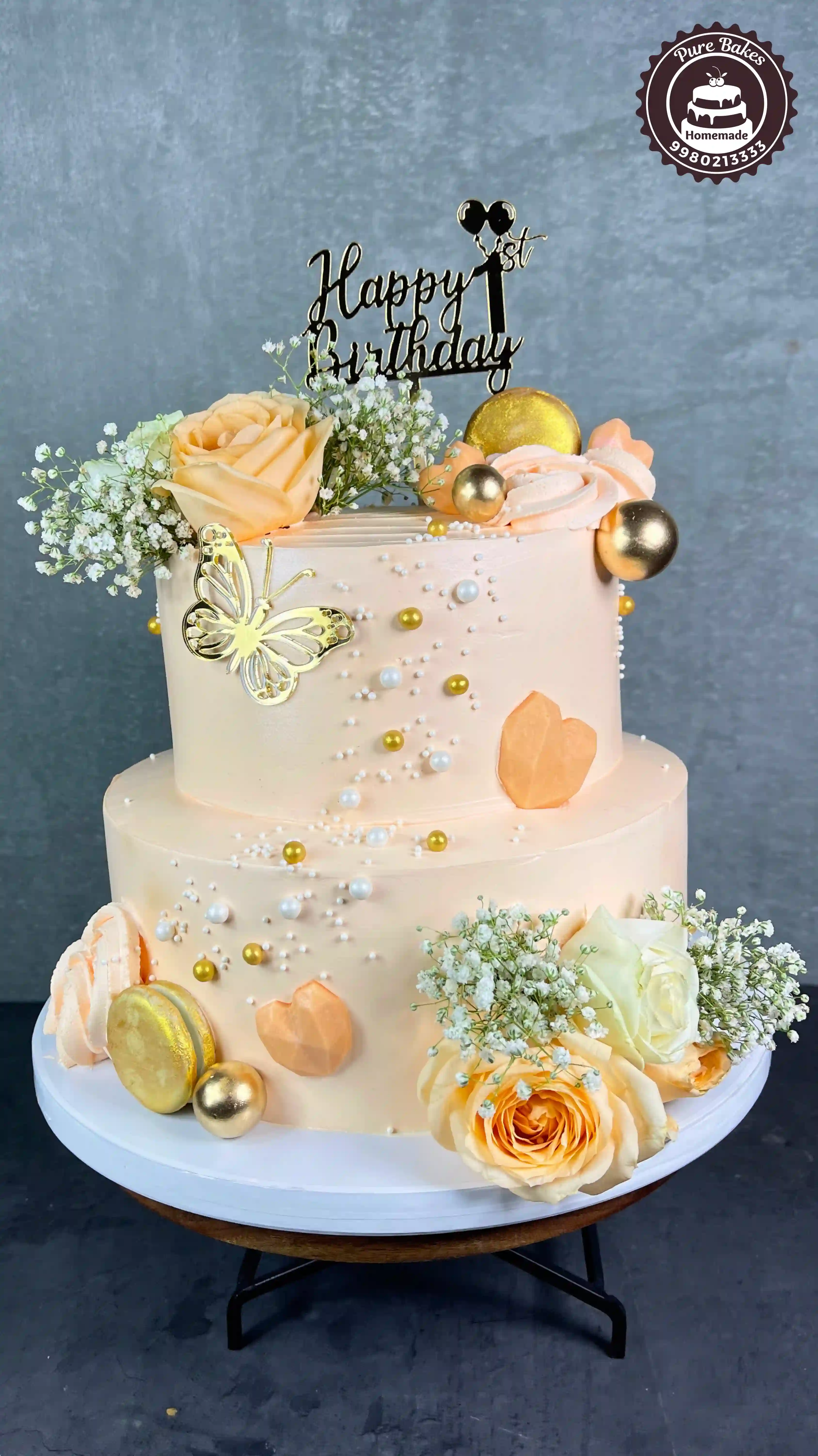 Two Tier First Birthday Cake With Roses And Golden Decor